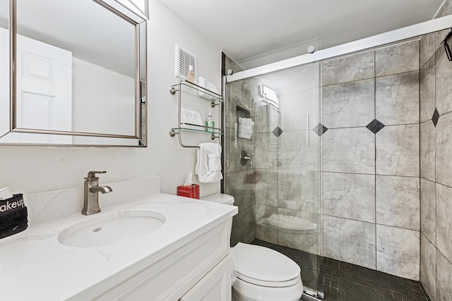 full bath with a shower stall, toilet, and vanity