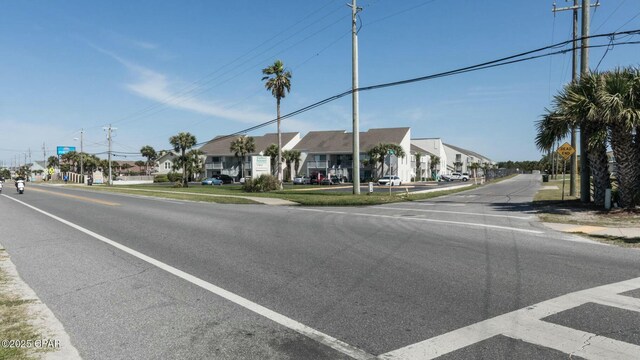 view of street with traffic signs, a residential view, and sidewalks