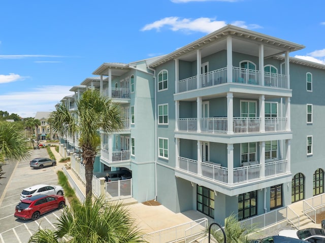 view of building exterior featuring uncovered parking