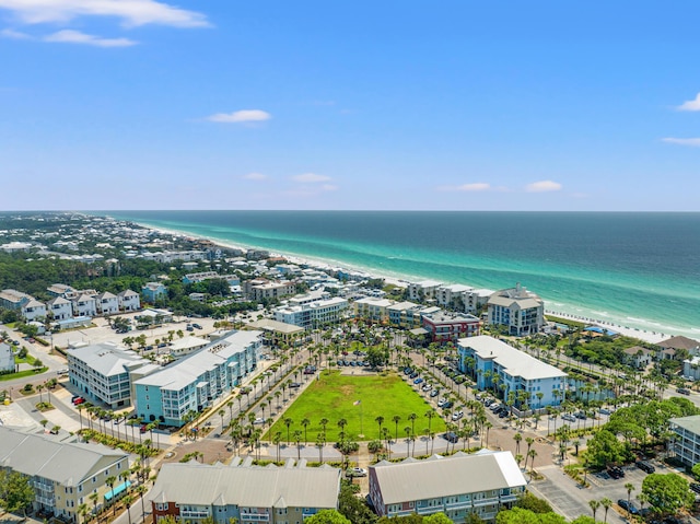 drone / aerial view with a water view, a view of city, and a beach view