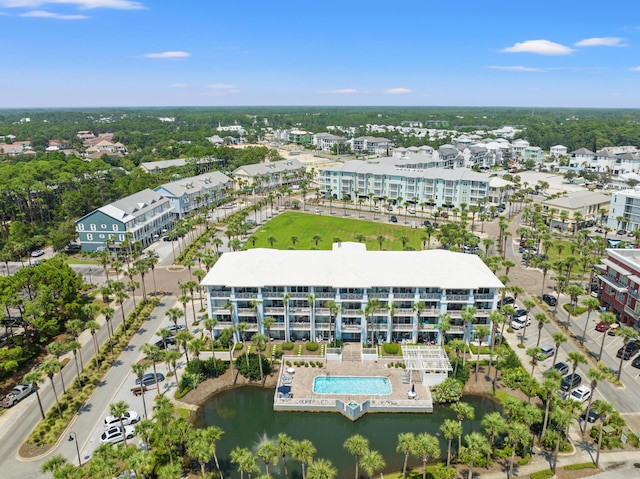 birds eye view of property with a water view and a city view