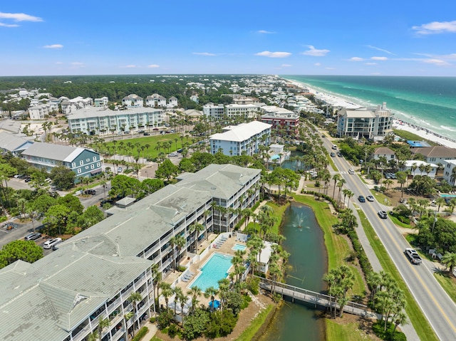 birds eye view of property featuring a water view and a beach view