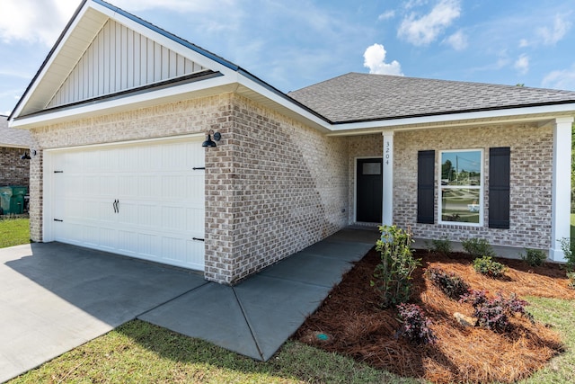 ranch-style house featuring a garage, a shingled roof, board and batten siding, brick siding, and concrete driveway