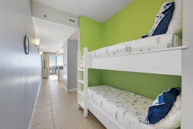 bedroom with visible vents, baseboards, and light tile patterned floors