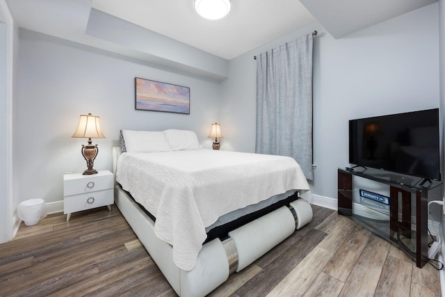 bedroom featuring dark wood-type flooring and baseboards