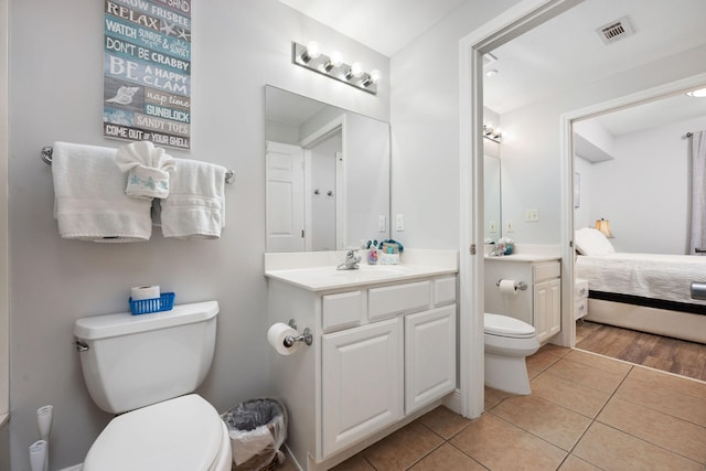 ensuite bathroom featuring ensuite bathroom, toilet, vanity, visible vents, and tile patterned floors