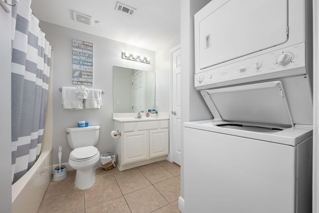 full bathroom with stacked washing maching and dryer, tile patterned flooring, visible vents, and vanity