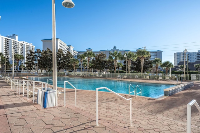 view of swimming pool with fence