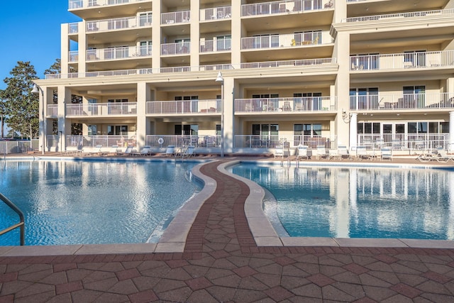 community pool featuring a patio area and fence