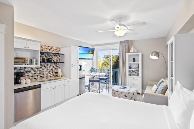 bedroom featuring access to exterior, a sink, and ceiling fan