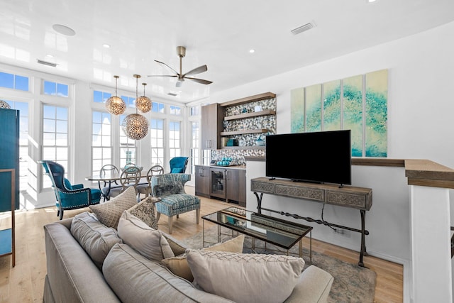 living area featuring visible vents, a ceiling fan, light wood-style flooring, wine cooler, and recessed lighting