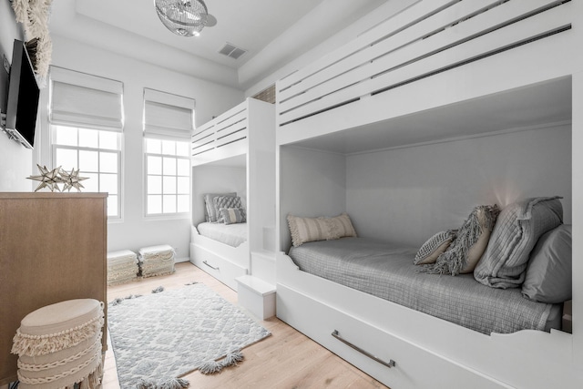 bedroom with visible vents and wood finished floors