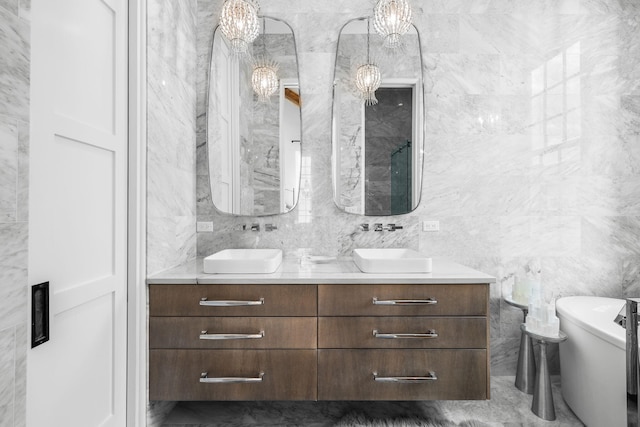 bathroom featuring double vanity, tile walls, toilet, and a sink