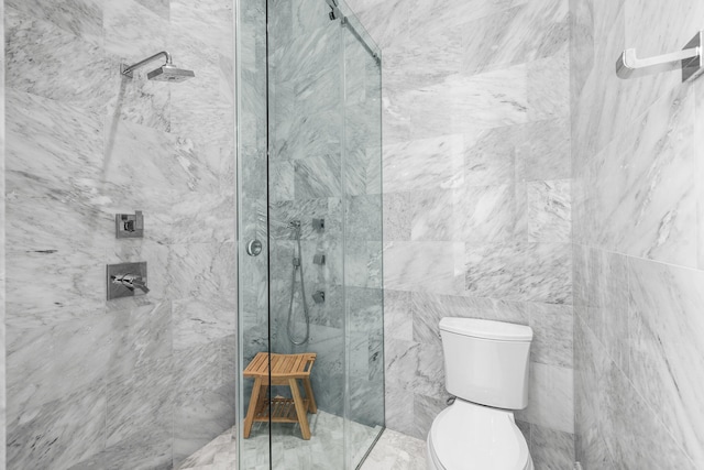 full bath featuring a marble finish shower and toilet