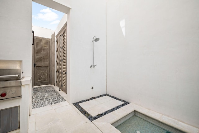 bathroom featuring tile patterned flooring and walk in shower