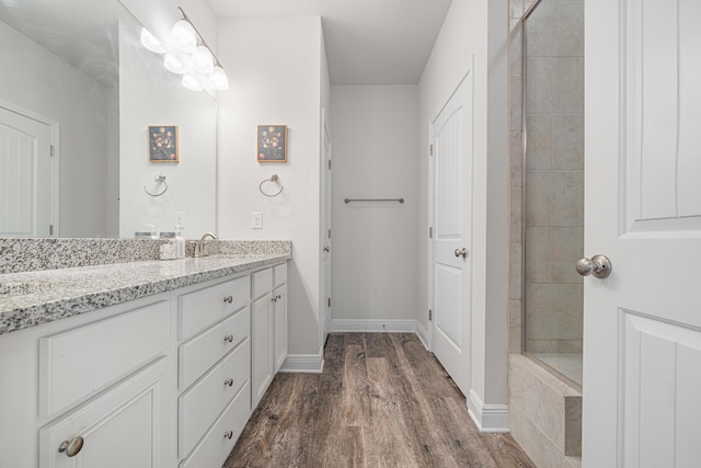 124 Conner Cir, Santa Rosa Beach, FL 32459 - full bathroom with baseboards, wood finished floors, and vanity
