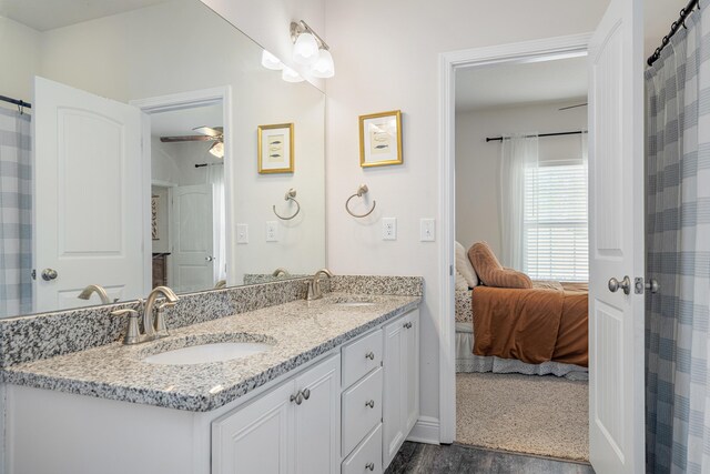 124 Conner Cir, Santa Rosa Beach, FL 32459 - ensuite bathroom with wood finished floors, connected bathroom, a sink, and double vanity