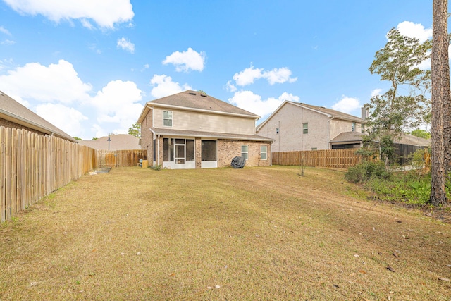 124 Conner Cir, Santa Rosa Beach, FL 32459 - rear view of house featuring a yard, brick siding, and a fenced backyard