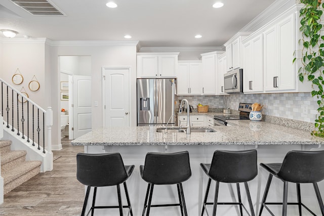 124 Conner Cir, Santa Rosa Beach, FL 32459 - kitchen featuring visible vents, appliances with stainless steel finishes, ornamental molding, white cabinetry, and a sink