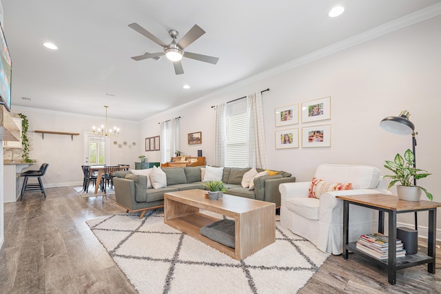 124 Conner Cir, Santa Rosa Beach, FL 32459 - living area featuring light wood-type flooring, crown molding, baseboards, and ceiling fan with notable chandelier