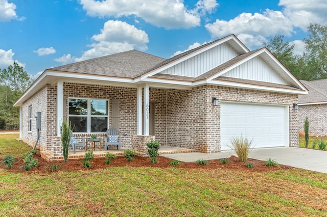 view of front facade with a garage, a front yard, covered porch, and concrete driveway