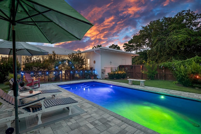 view of swimming pool featuring a fenced in pool, a yard, a patio area, and fence