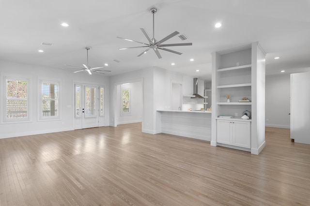 unfurnished living room featuring a healthy amount of sunlight, light wood finished floors, a ceiling fan, and recessed lighting