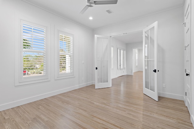 unfurnished room featuring crown molding, french doors, visible vents, and light wood-style floors