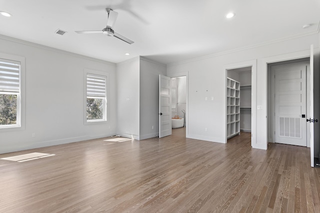 unfurnished bedroom featuring visible vents, wood finished floors, and ornamental molding