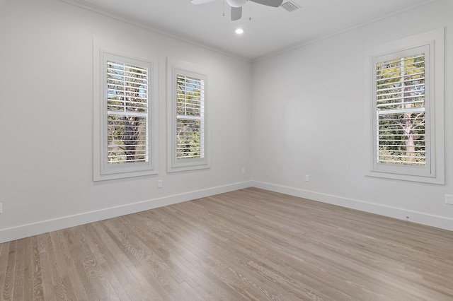 empty room with crown molding, light wood-style flooring, baseboards, and ceiling fan