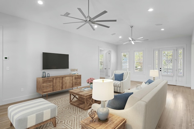 living room with a ceiling fan, recessed lighting, light wood-style flooring, and baseboards