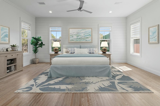 bedroom featuring baseboards, crown molding, visible vents, and wood finished floors