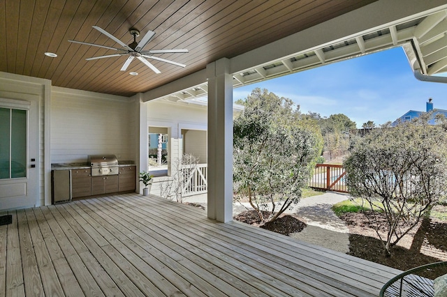 wooden deck featuring ceiling fan, area for grilling, and fence