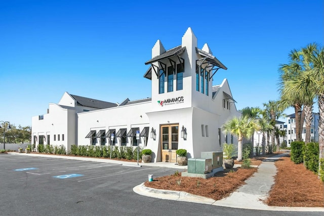 view of building exterior featuring uncovered parking