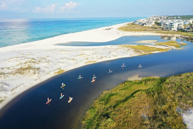 birds eye view of property featuring a water view and a beach view