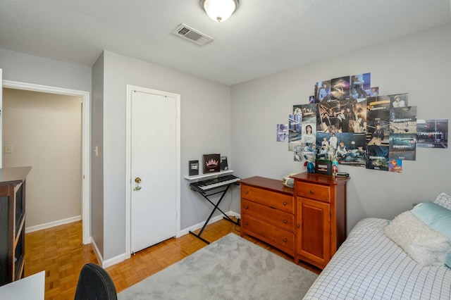 bedroom featuring visible vents and baseboards