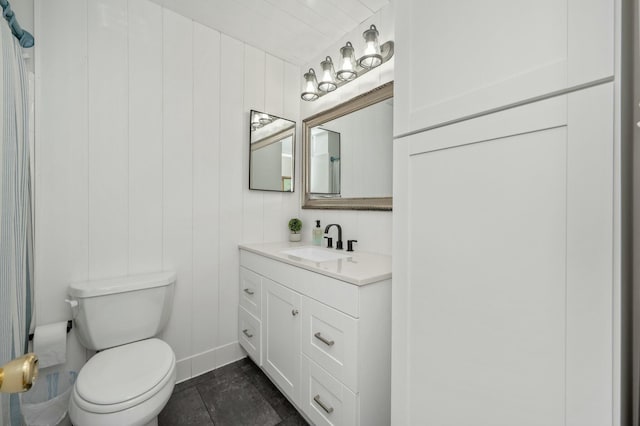 half bathroom with toilet, tile patterned flooring, and vanity