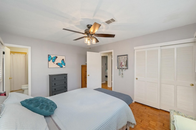 bedroom featuring a ceiling fan, connected bathroom, visible vents, and a closet