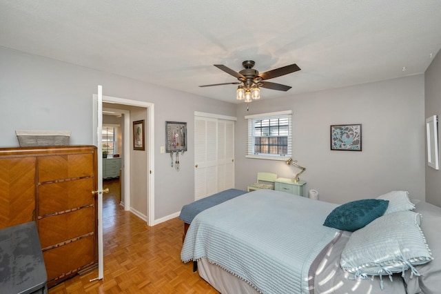 bedroom featuring ceiling fan, baseboards, and a closet