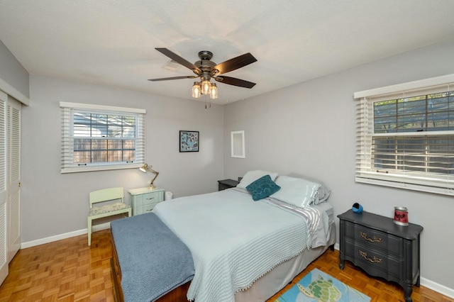 bedroom with a ceiling fan, baseboards, and a closet