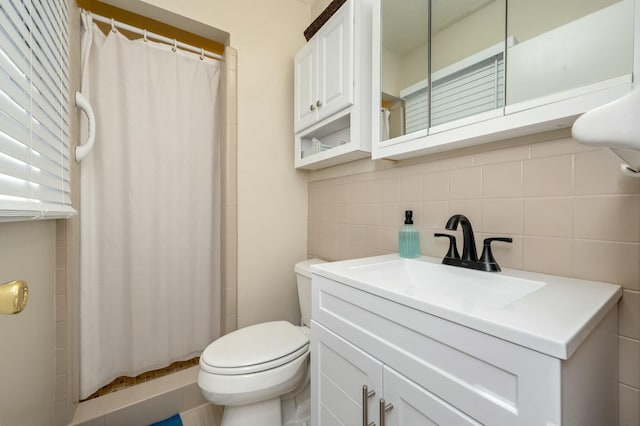 full bathroom featuring a shower stall, toilet, and vanity