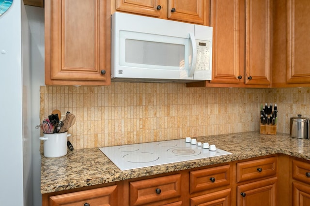 kitchen featuring white appliances, stone countertops, decorative backsplash, and brown cabinets