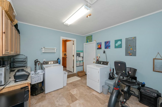 laundry area featuring ornamental molding, cabinet space, washing machine and clothes dryer, and electric panel