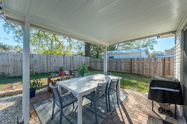 view of patio / terrace featuring outdoor dining area, area for grilling, and a fenced backyard