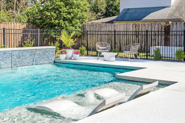 view of swimming pool featuring a fenced in pool, fence private yard, and a patio