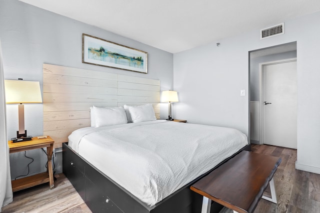 bedroom with wood finished floors and visible vents