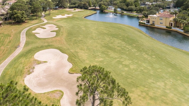 birds eye view of property with a water view and golf course view