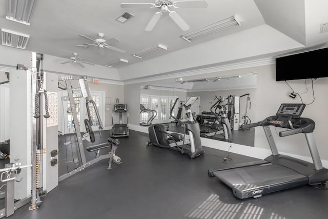 gym with a raised ceiling, visible vents, and baseboards