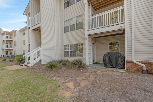 exterior space featuring stairway and central AC unit