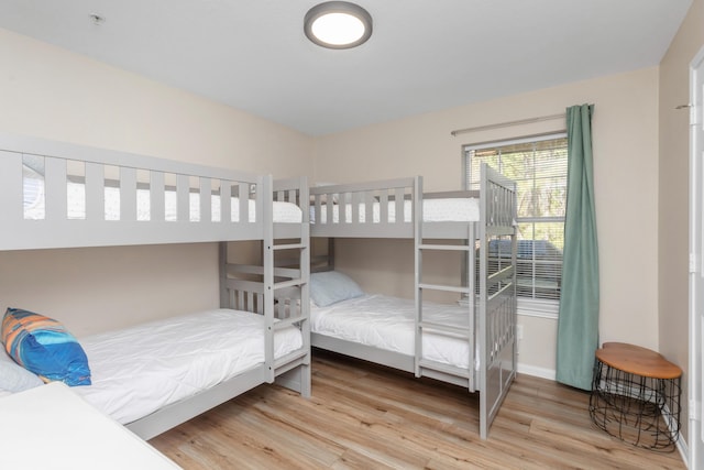 bedroom featuring baseboards and wood finished floors